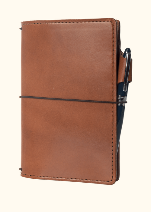 An Austen leather notebook with a closure elastic and pen loop. The collection name is Austen and the color is called Darcy (Toffee Brown) - ChicSparrow
