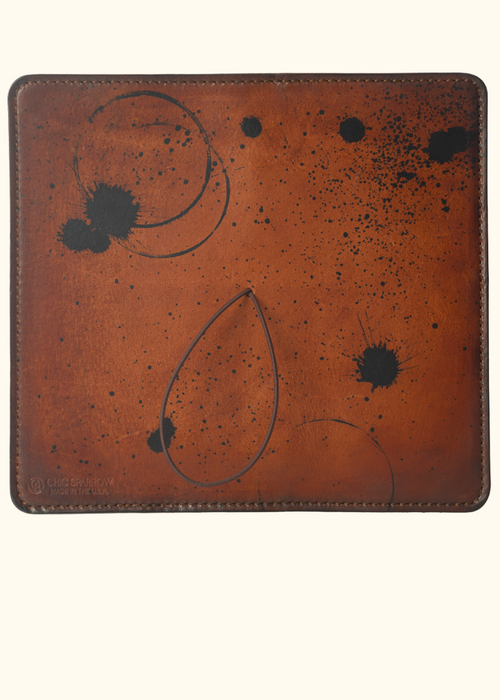 This is an example of what antiquing looks like on a Darcy. Antiquing is when an artist applies dye to make markings like splatters and cup rings on a leather notebook to make it look older. - ChicSparrow