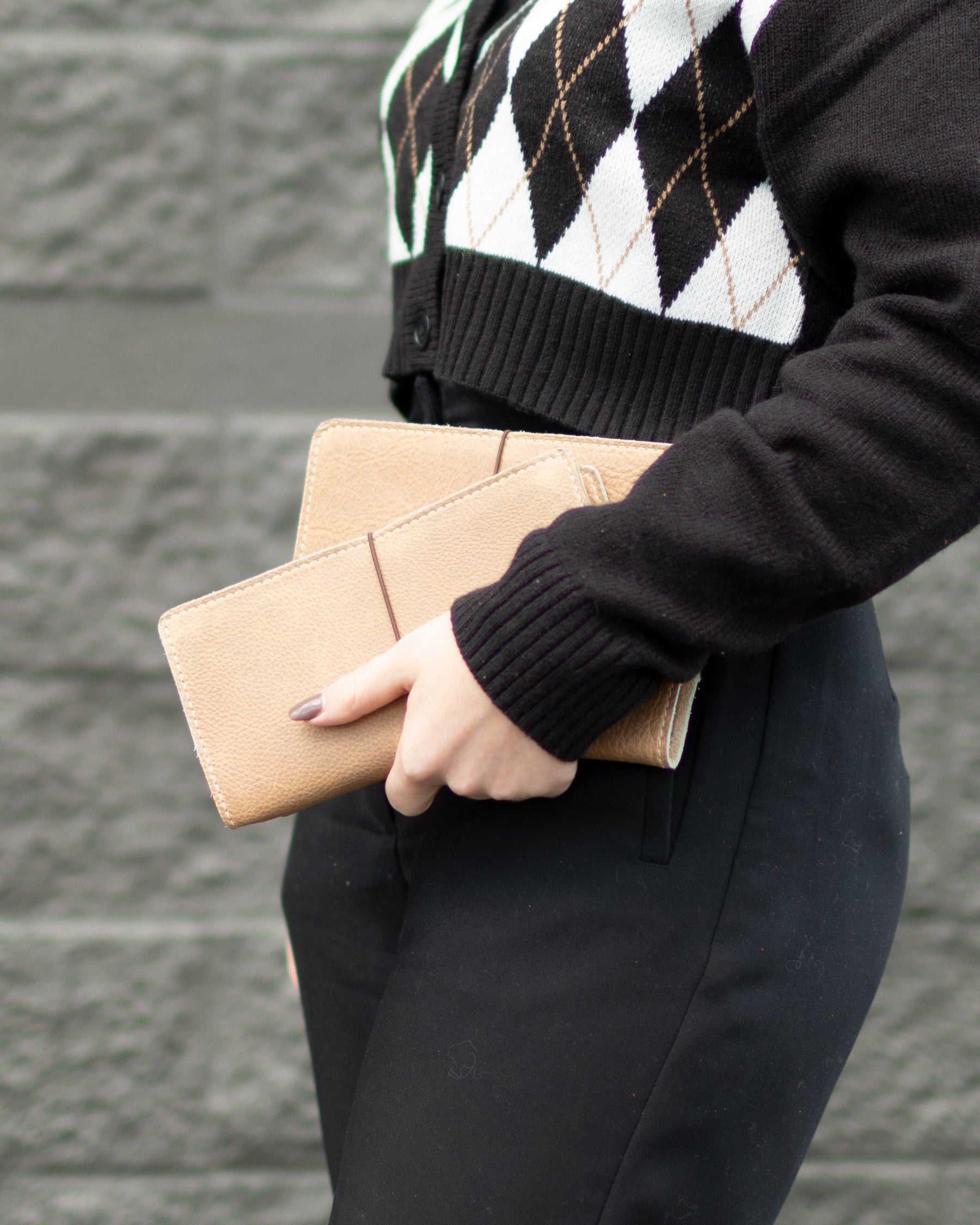 Women holding our June Newsletter: New Dundee, Cardholder, Meteorite Set