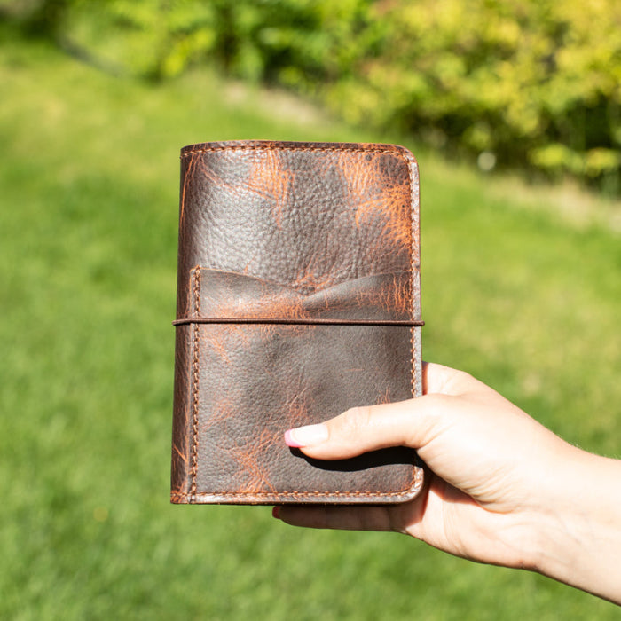 Brown leather pocket size notebook.