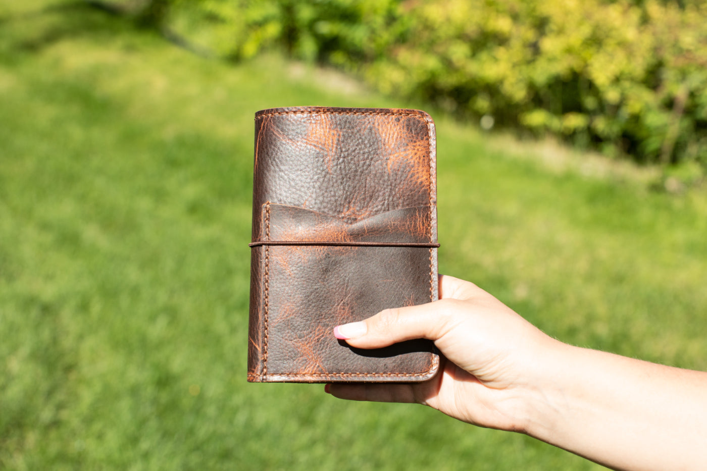 Brown leather pocket size notebook.