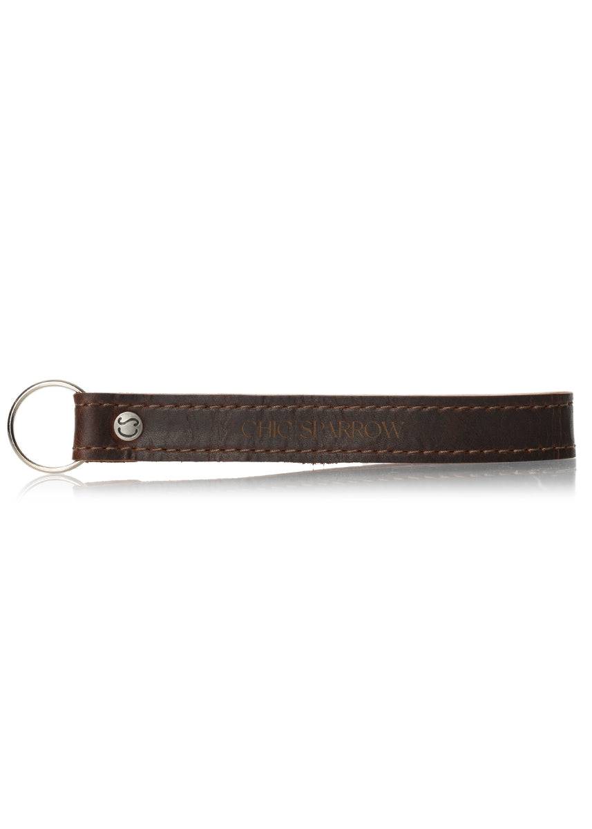 Leather key fob with Chic Sparrow logo. Leather keychain with key ring and rivet.
