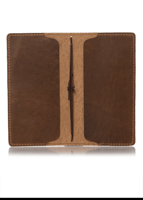 Brown leather notebook cover for Hobonichi Weeks planner. Two inside pockets and two strings to hold inserts.