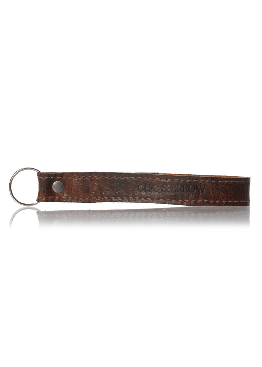 Brown leather key fob with Chic Sparrow logo. Leather keychain with key ring and rivet.
