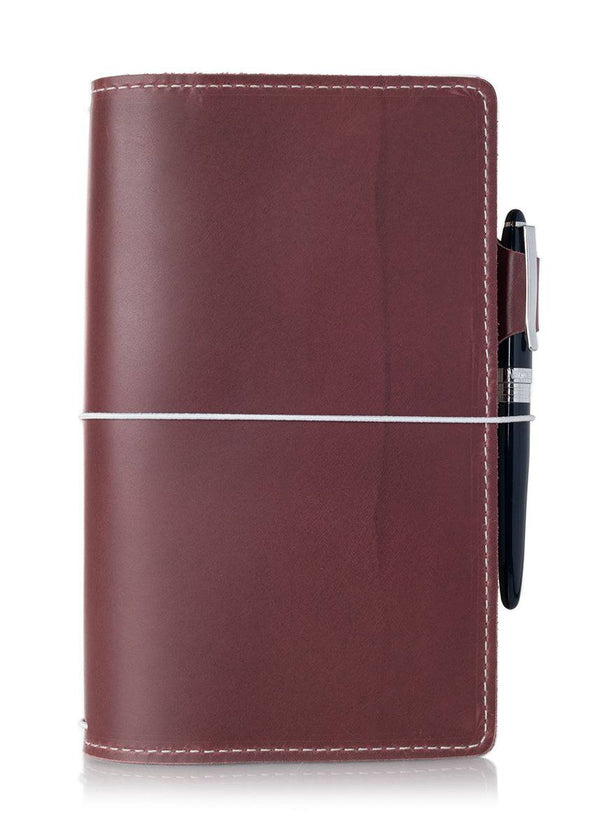 Purple leather travelers notebook journal cover with elastic closure.