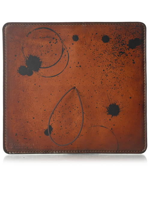 This is an example of what antiquing looks like on a Darcy. Antiquing is when an artist applies dye to make markings like splatters and cup rings on a leather notebook to make it look older. - ChicSparrow
